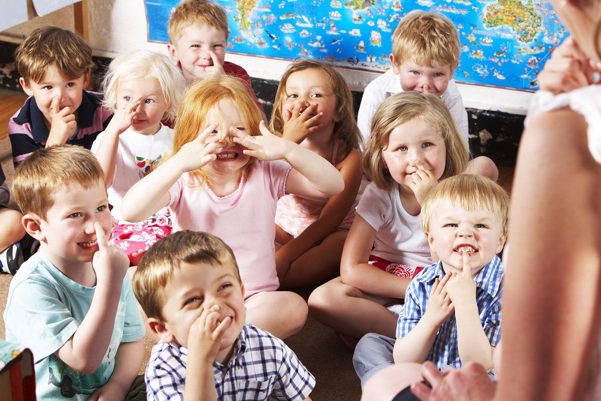 Children learning with a staff member at out pre-school